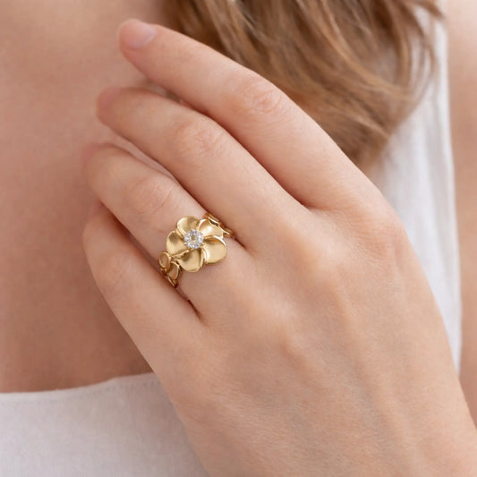 Model wearing YUBIRAA Flora Spark floral solitaire ring featuring elegant gold plated petals and crystal centerpiece for everyday styling