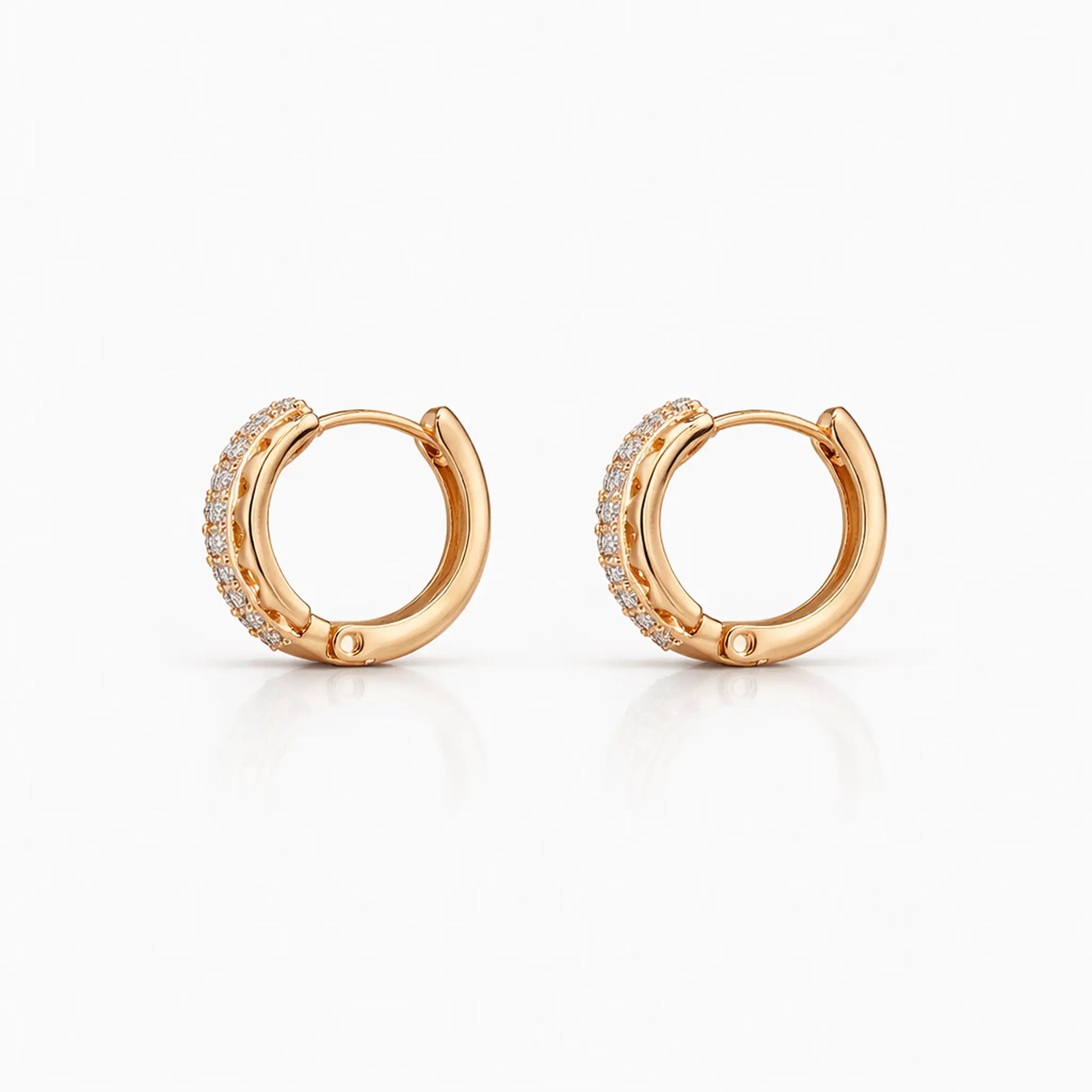 Anti-tarnish gold plated pavé hoop earrings with sparkling cubic zirconia stones shown in an angled view on a white background