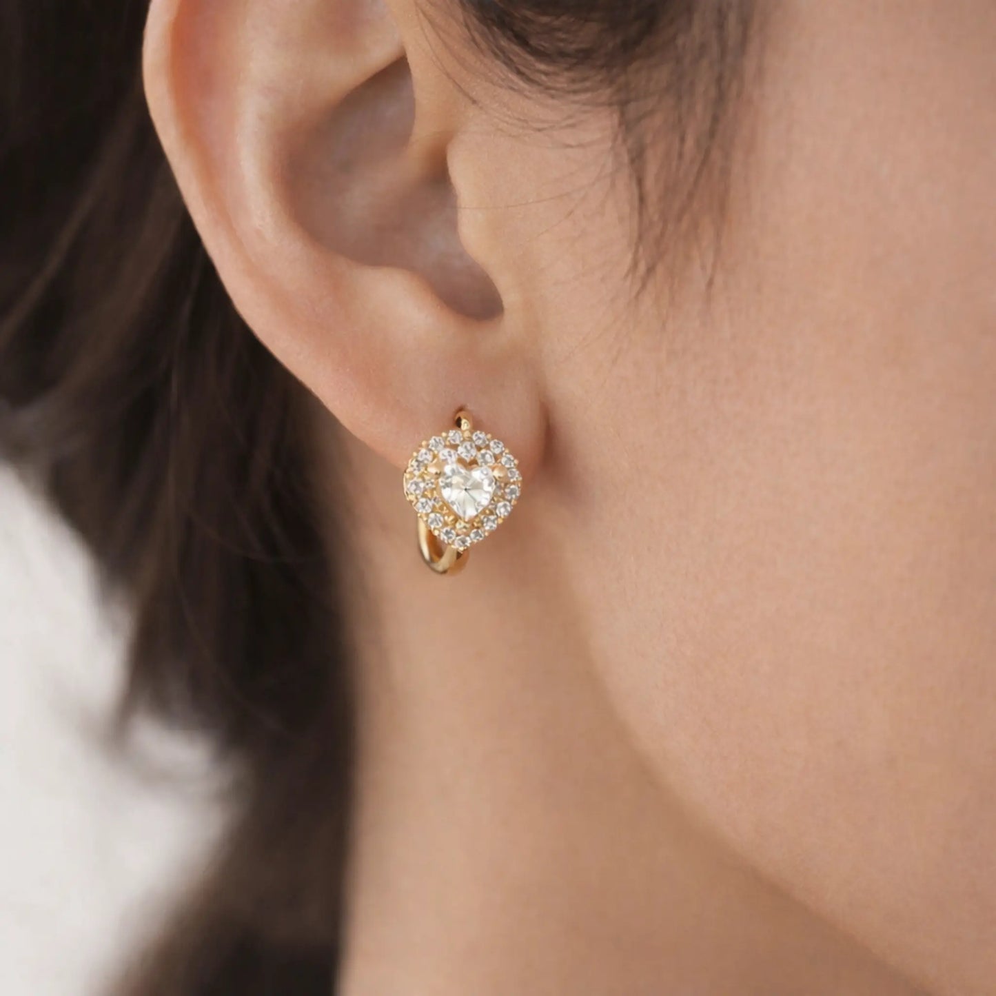 Close-up of anti tarnish gold polish heart crystal hoop earrings highlighting premium finish