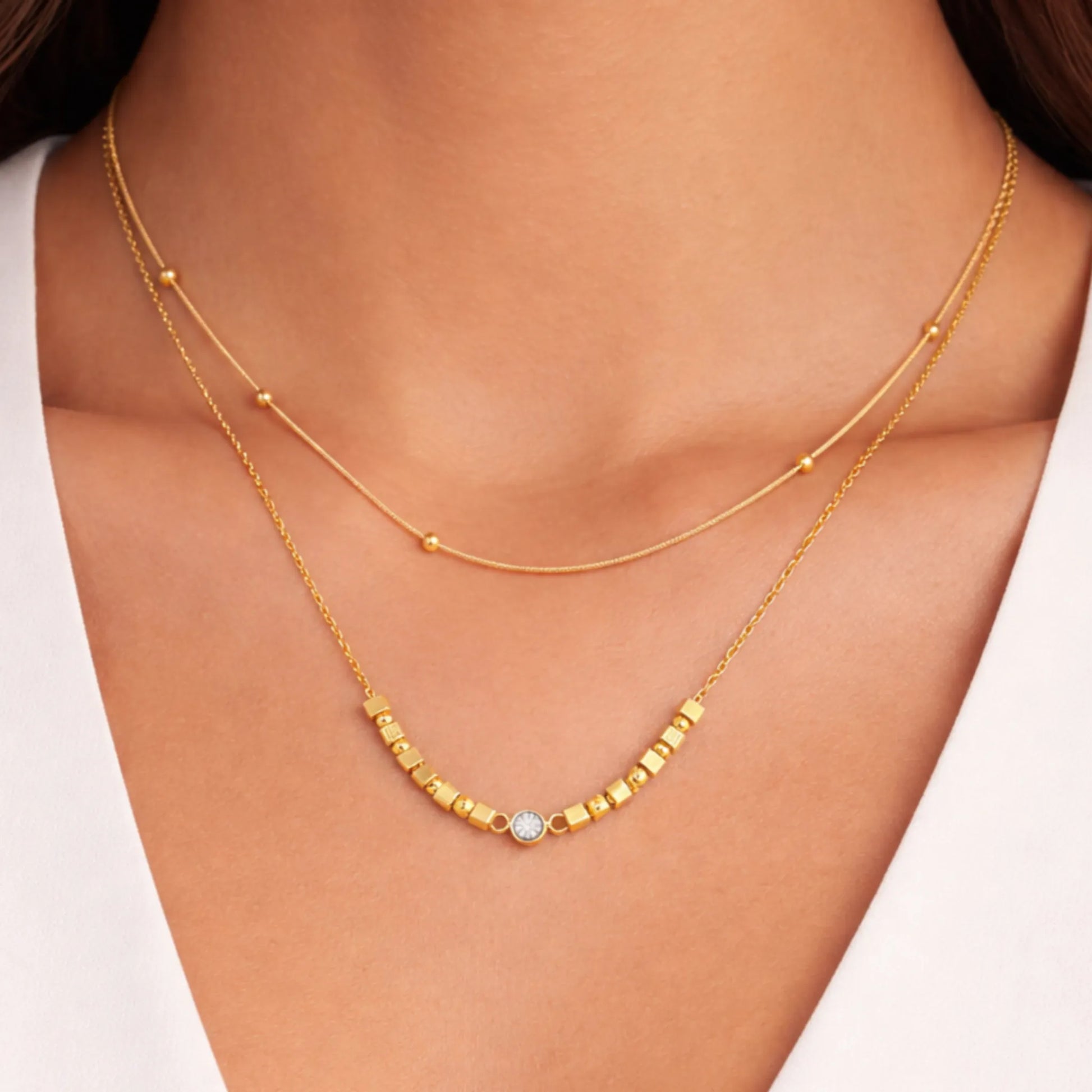 Woman wearing YUBIRAA LayerLuxe Bead Necklace gold layered minimal chain for elegant styling