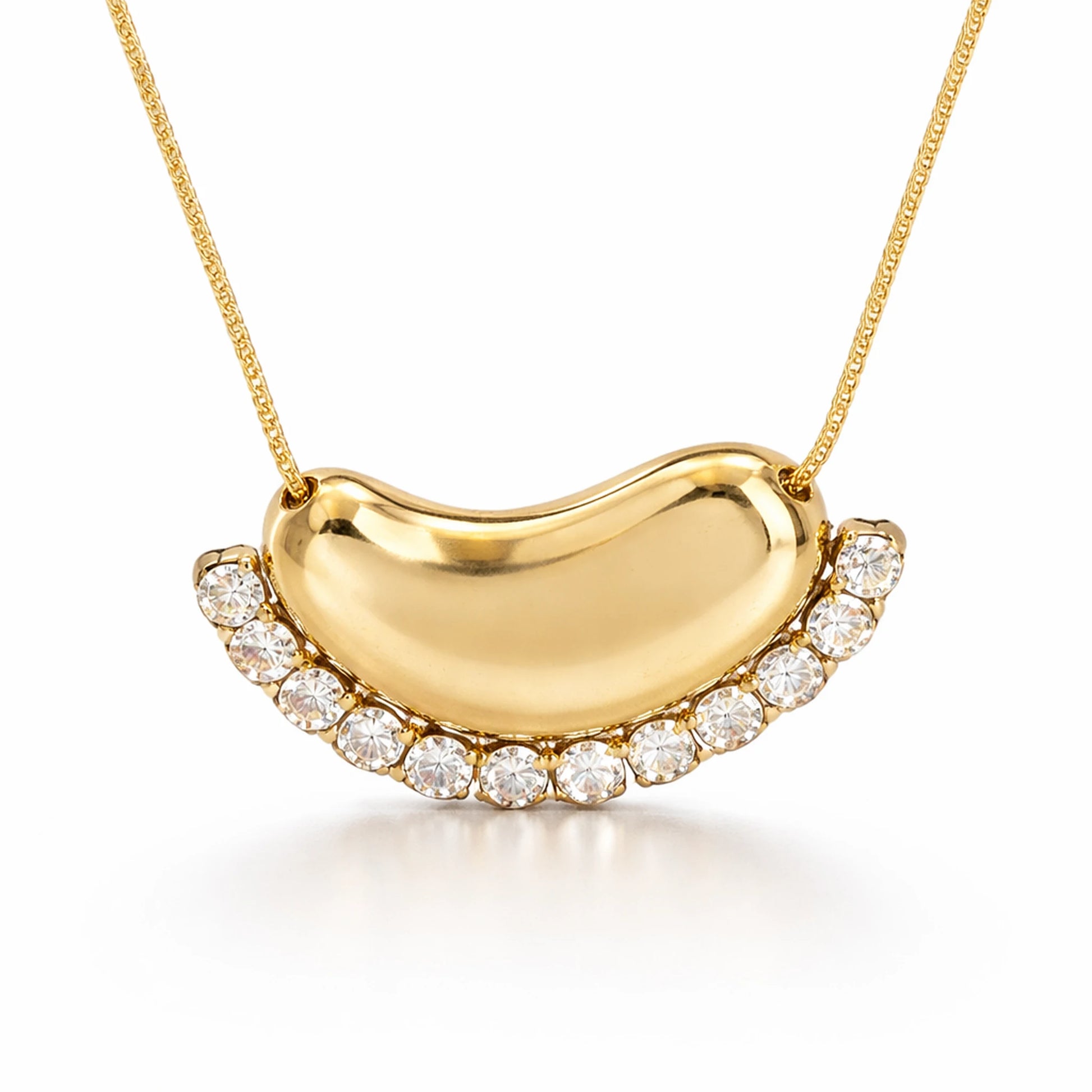 Gold necklace with a moon shaped pendant on a white background