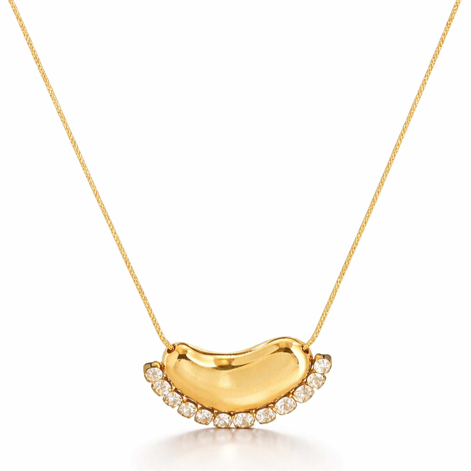 Gold necklace with a crescent moon pendant on a white background