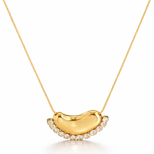 Gold necklace with a crescent moon pendant on a white background