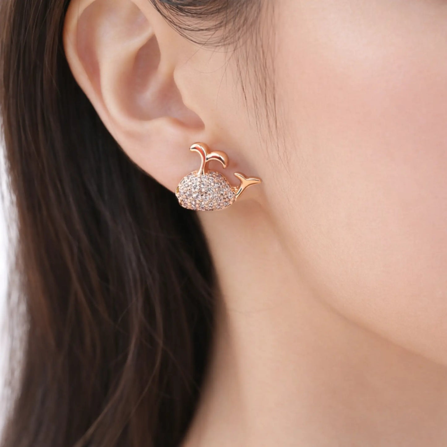 Anti-tarnish gold plated whale stud earrings displayed as a front-facing pair with sparkling cubic zirconia stones