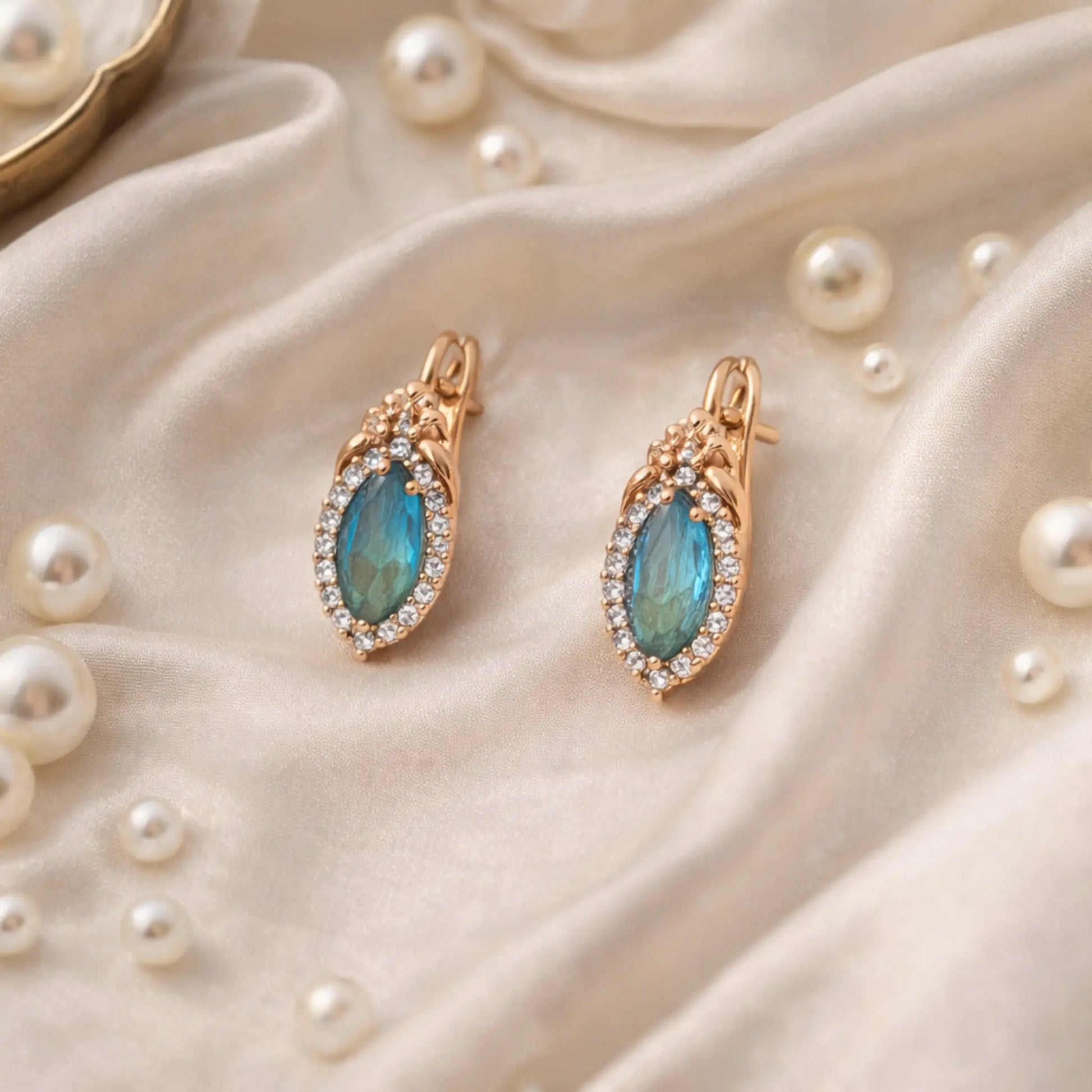 Anti tarnish gold polish blue stone earrings displayed on satin cloth with pearls luxury lifestyle image