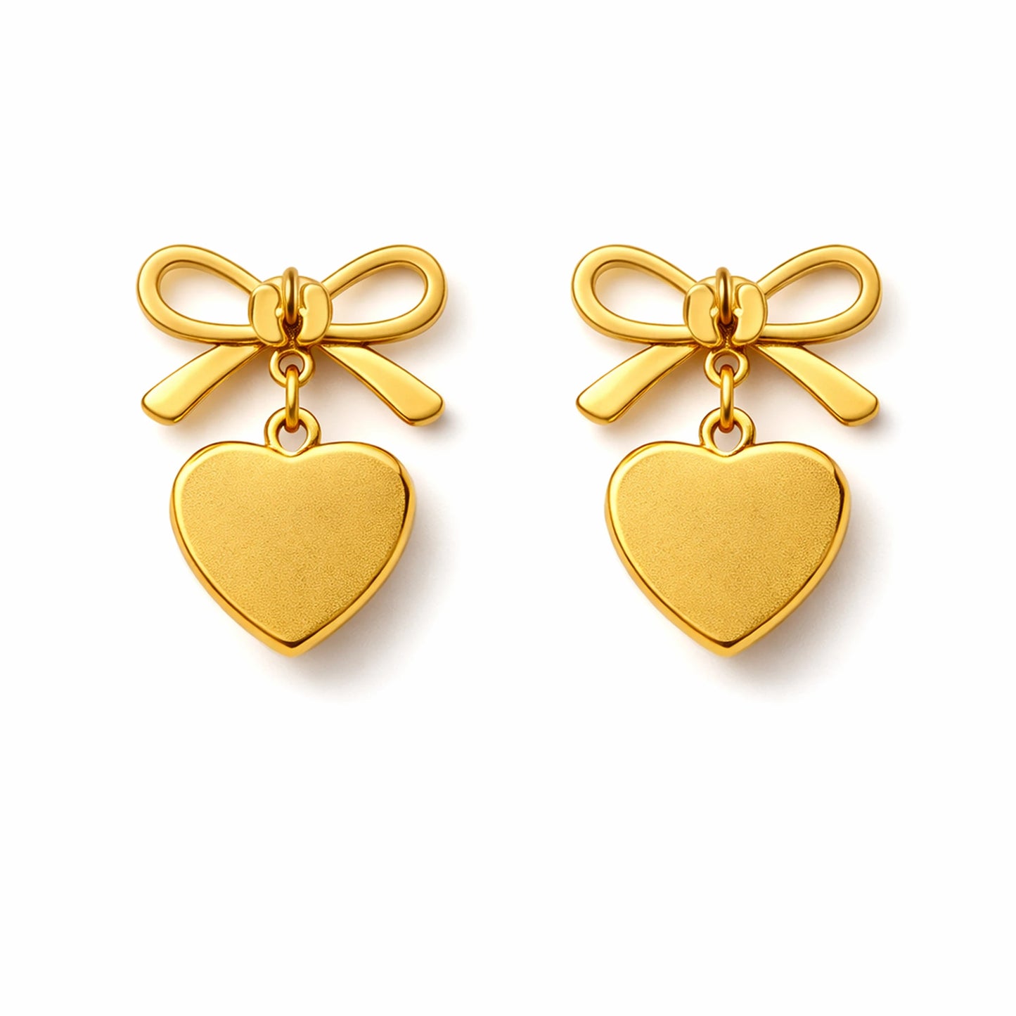 Gold bow and heart earrings on a white background