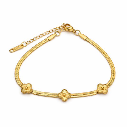 Gold bracelet with floral designs on a white background