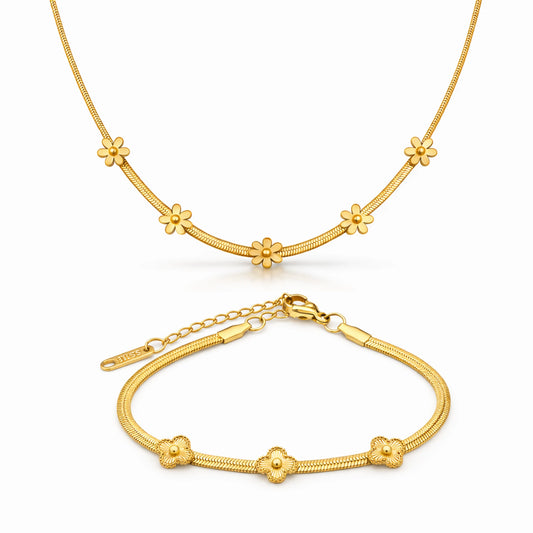 Gold necklace and bracelet set on a white background