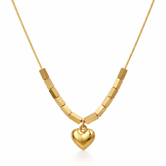 Gold necklace with a heart pendant on a white background
