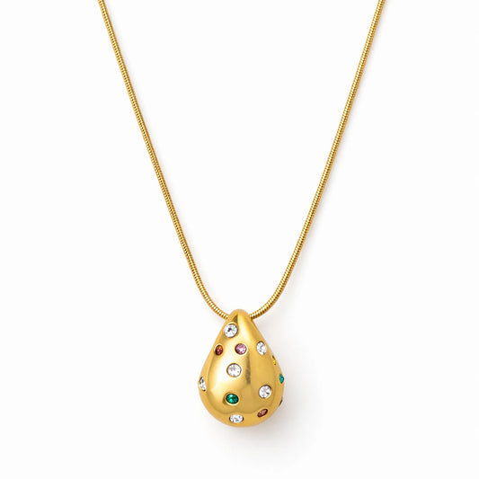 Gold necklace with a teardrop-shaped pendant featuring gemstones on a white background
