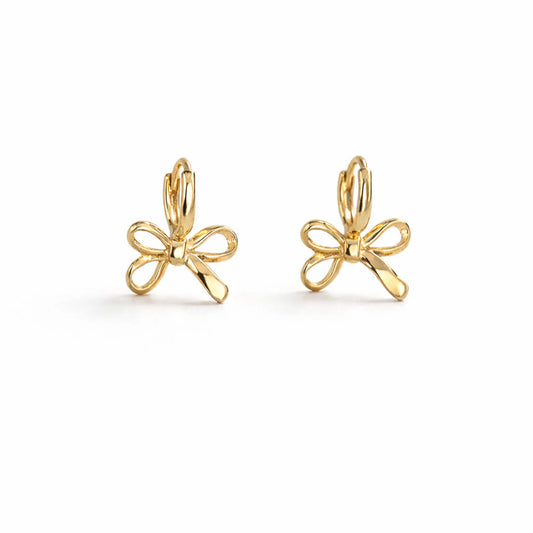 Gold bow-shaped earrings on a white background