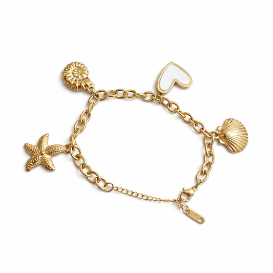 Gold bracelet with starfish, heart, and shell charms on a white background