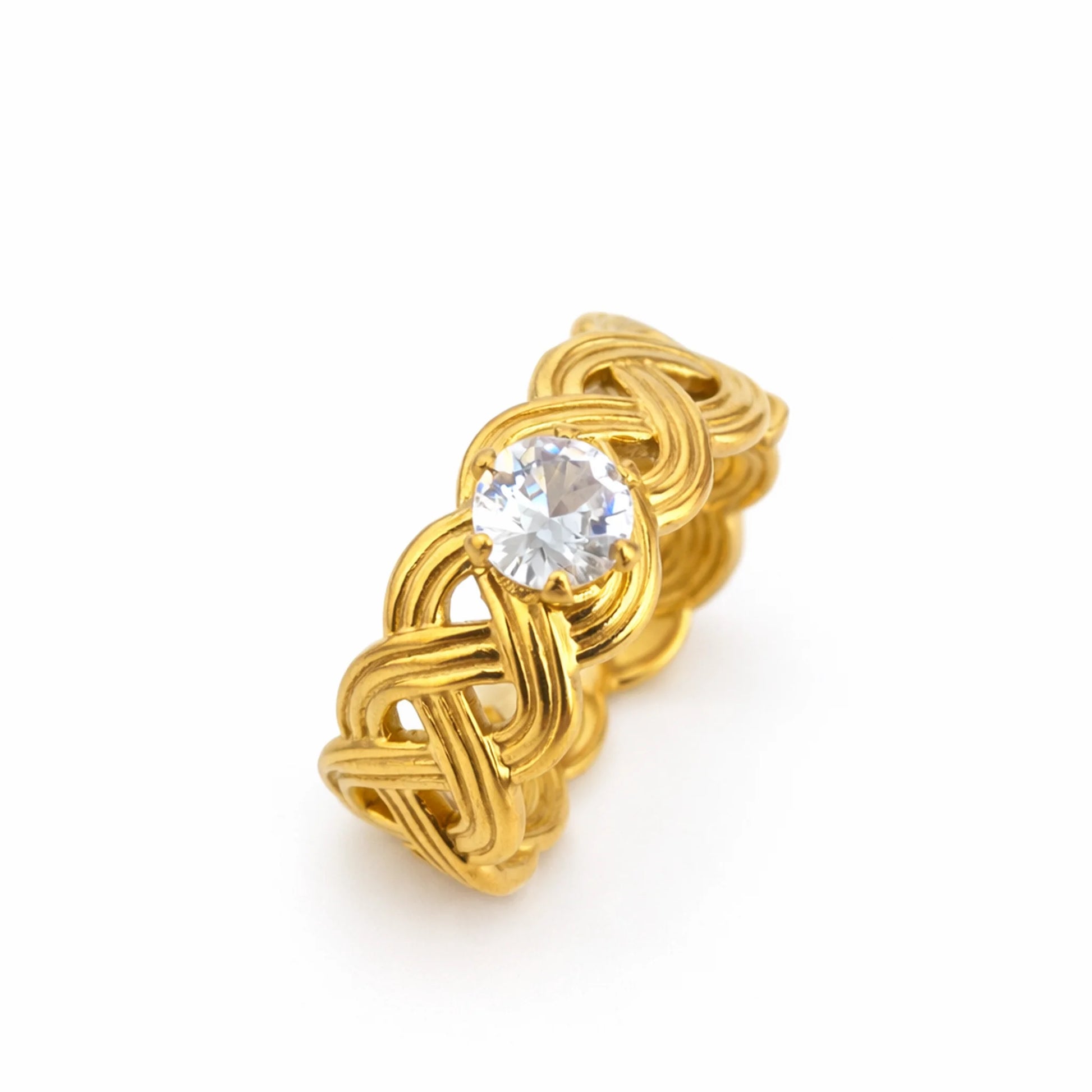 Close-up of infinity knot solitaire ring featuring intertwined gold loops and sparkling center stone