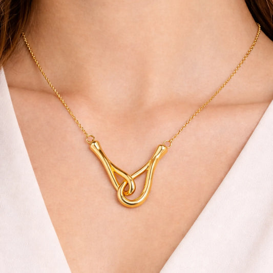 Model wearing the Interlock Curve Necklace with a minimal anti tarnish gold plated finish