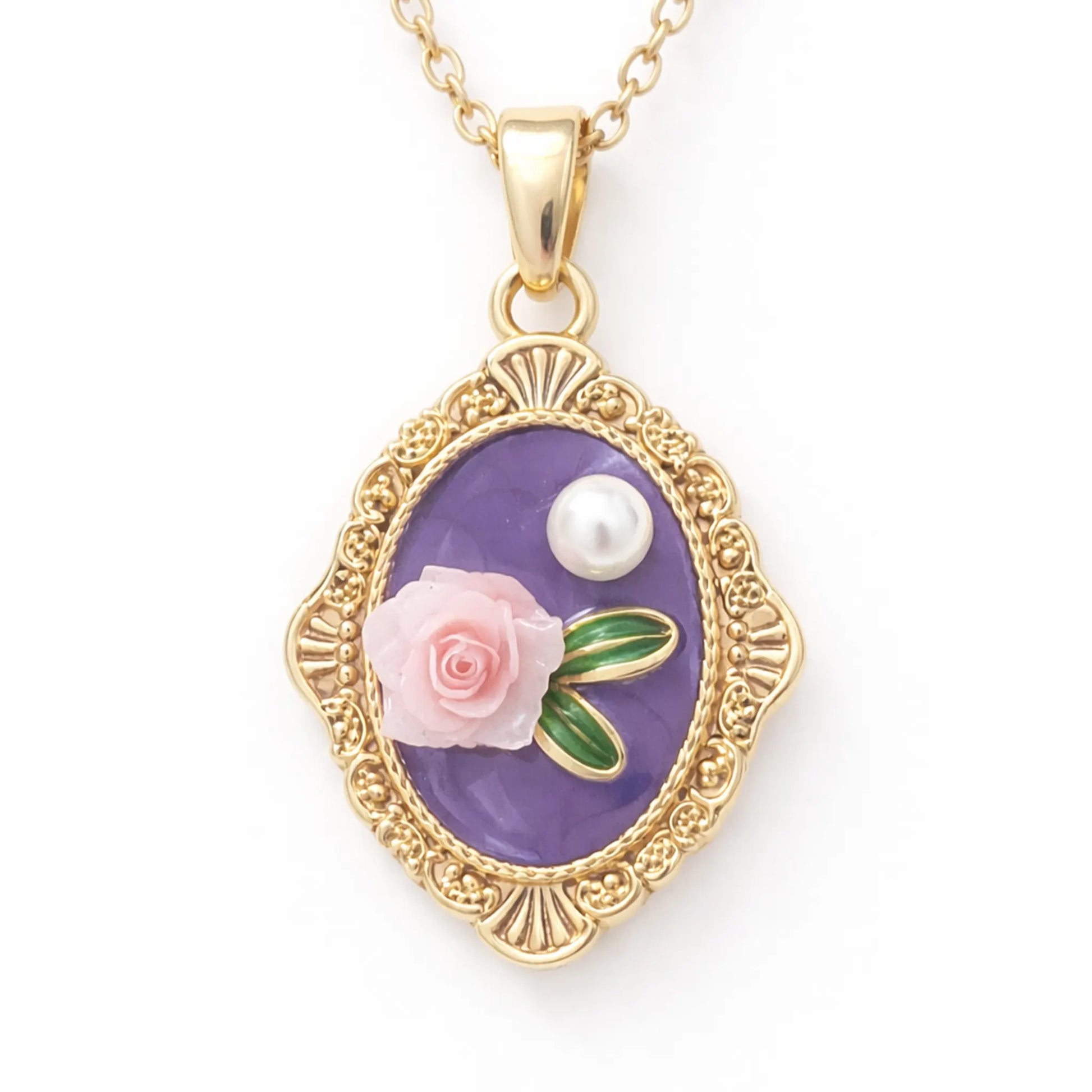 Close-up of anti-tarnish gold plated vintage oval pendant with purple enamel base, raised pink rose motif, green leaf detailing, and pearl accent.