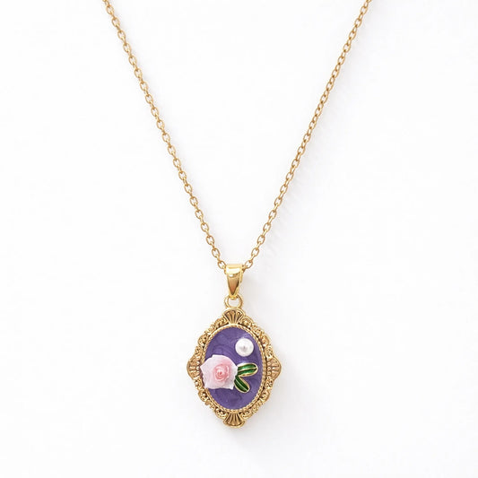 Anti-tarnish gold plated vintage rose necklace with ornate oval frame and floral enamel pendant displayed on a clean white background.