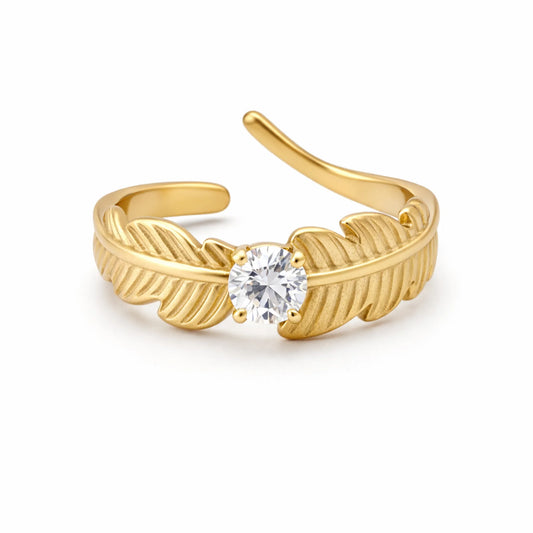YUBIRAA Leaf of Light Solitaire Ring in 18K gold plated stainless steel featuring a leaf-inspired design with a sparkling solitaire stone, front view on white background.