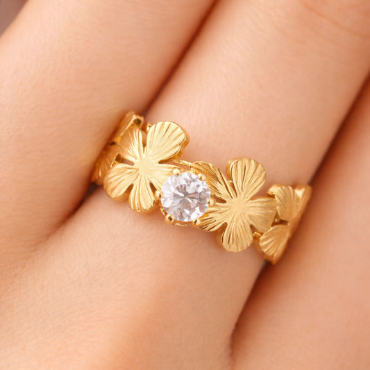Model wearing gold love in bloom flower ring with sparkling solitaire stone and floral petal design – yubiraa