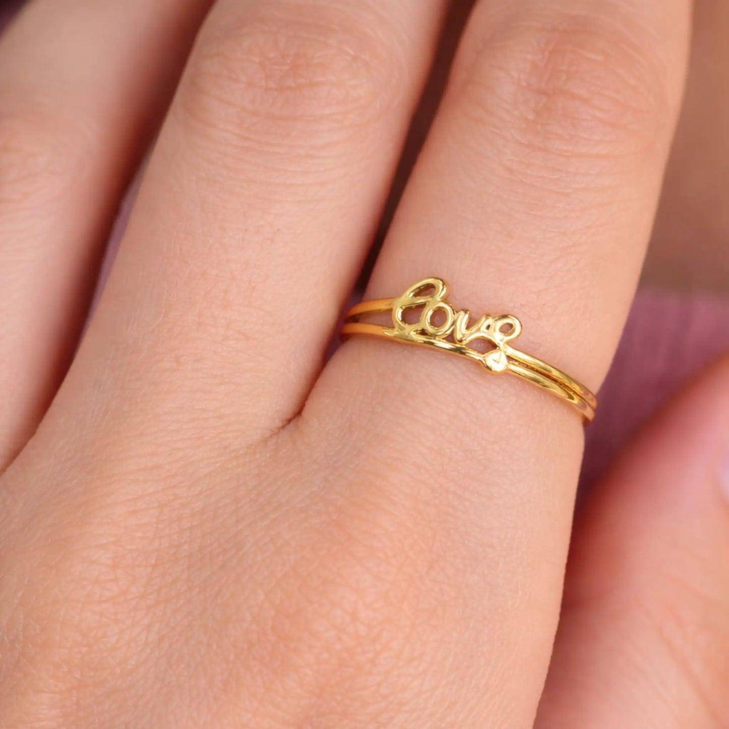 Model wearing YUBIRAA love script adjustable gold ring, minimal everyday jewellery styling