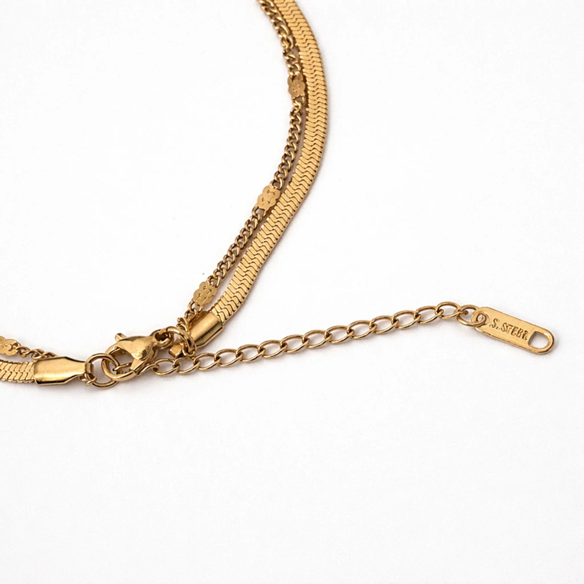 Gold chain bracelet with a clasp on a white background