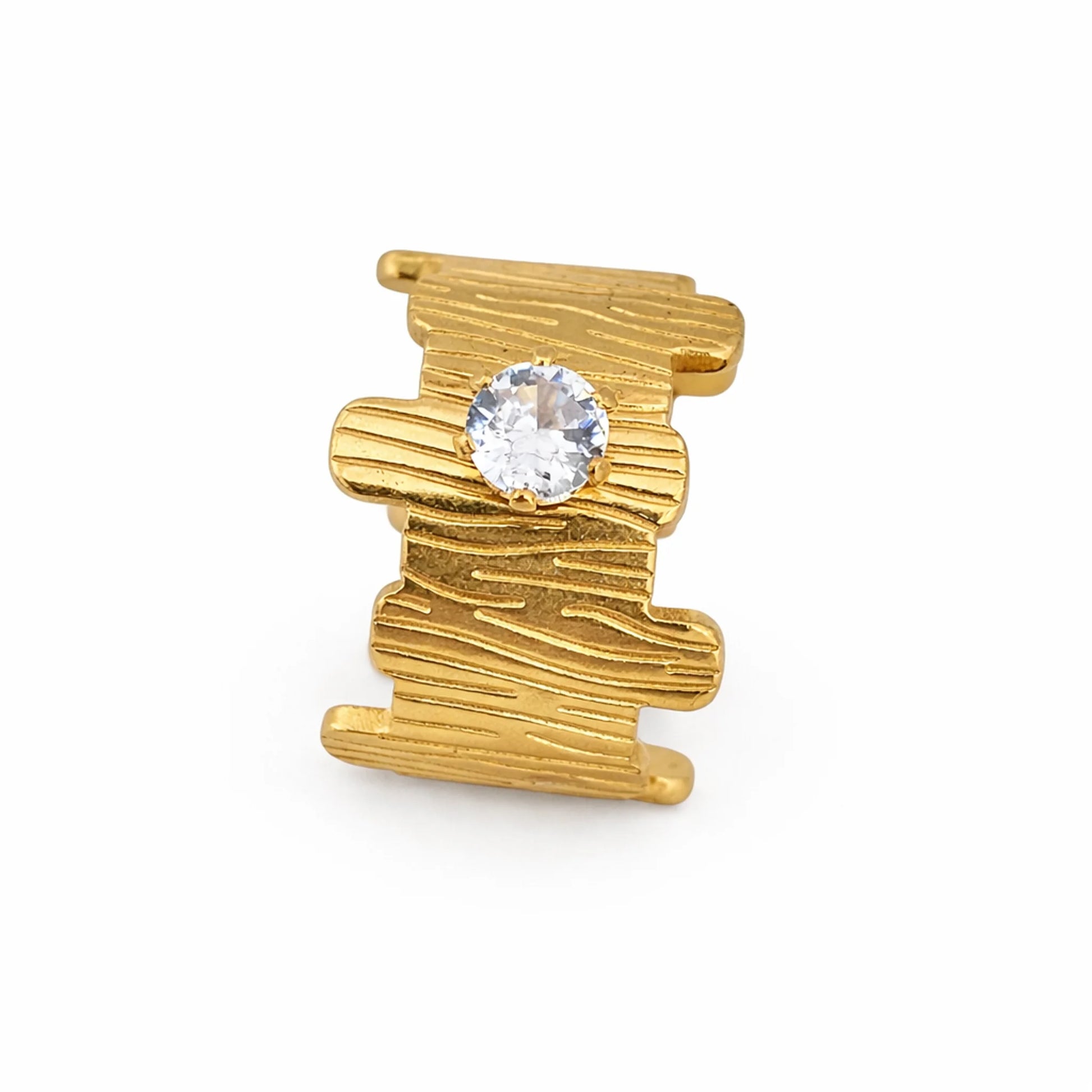 Wide band gold plated ring with organic texture and solitaire stone, side standing view on a white background