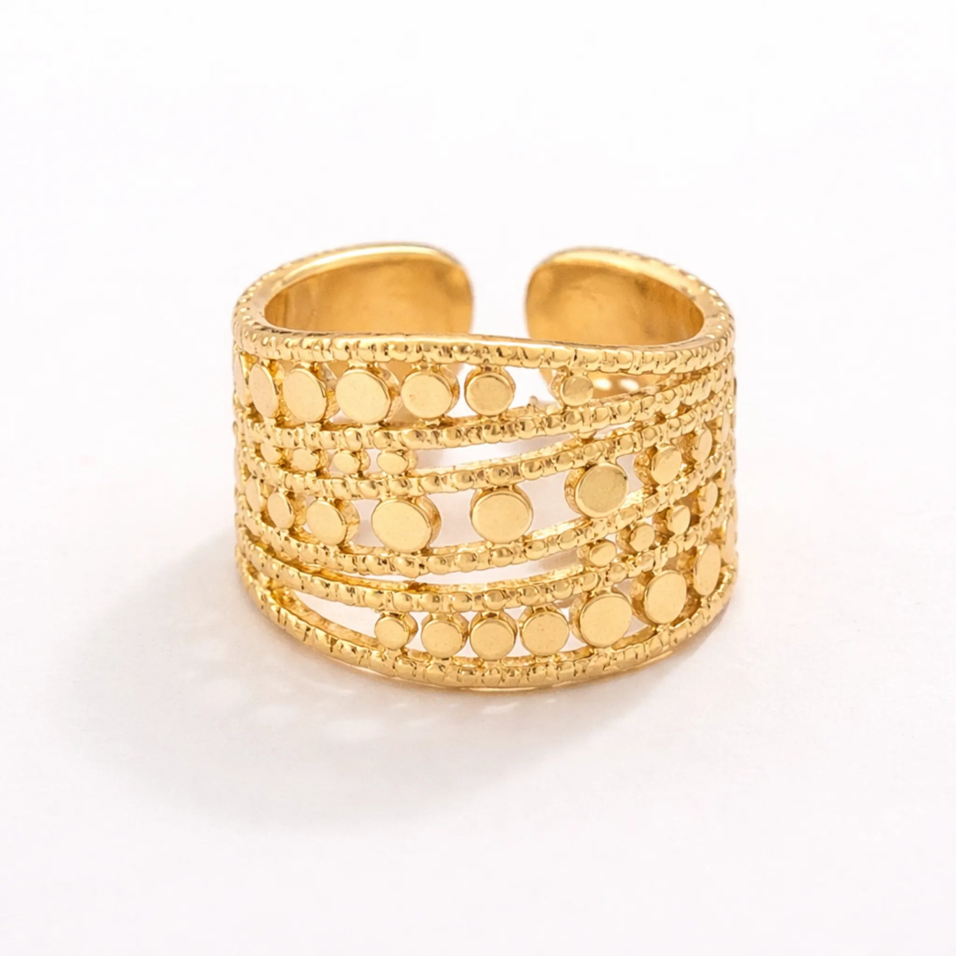 Gold adjustable multi-disc ring with layered textured band on white background