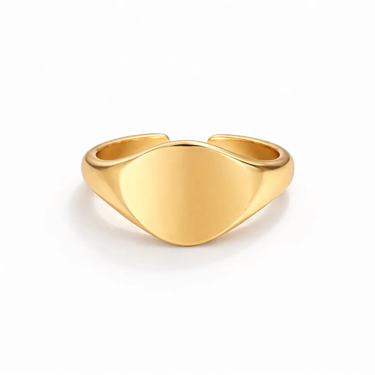 Gold adjustable signet ring with smooth polished surface on white background