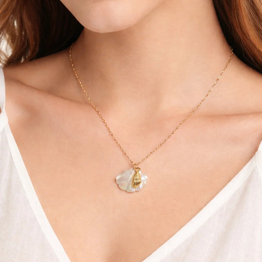 Model wearing gold shell pendant necklace with iridescent mother of pearl charm, minimal everyday jewellery styling