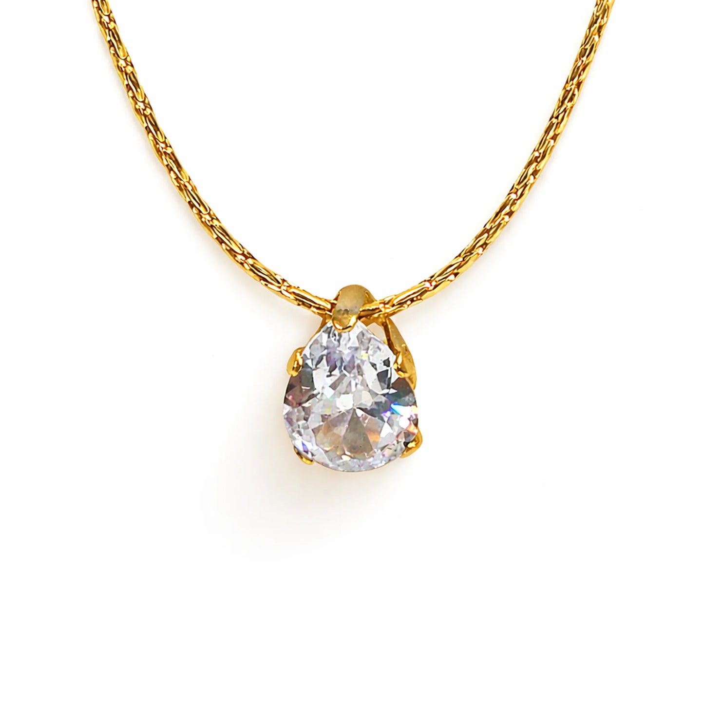Gold necklace with a teardrop-shaped diamond pendant on a white background