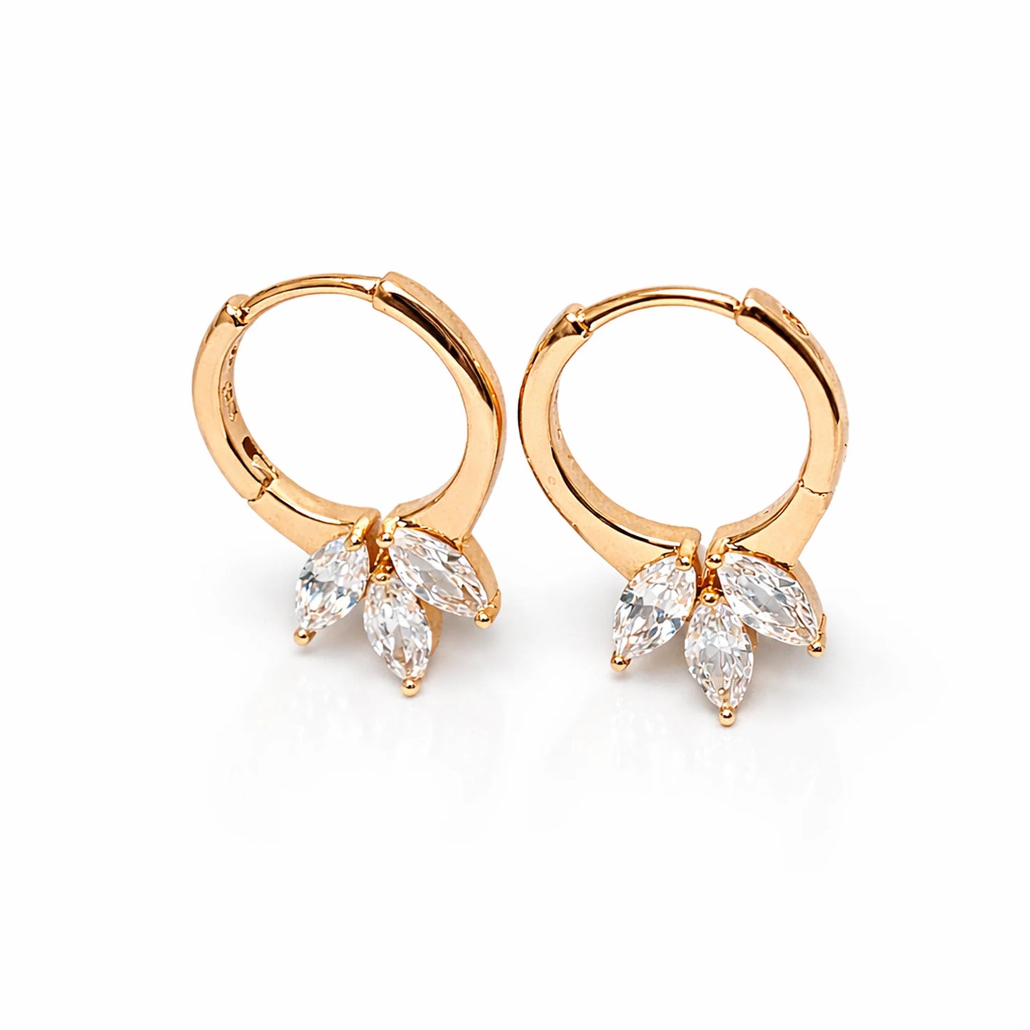 Gold hoop earrings with marquise-shaped gemstones on a white background