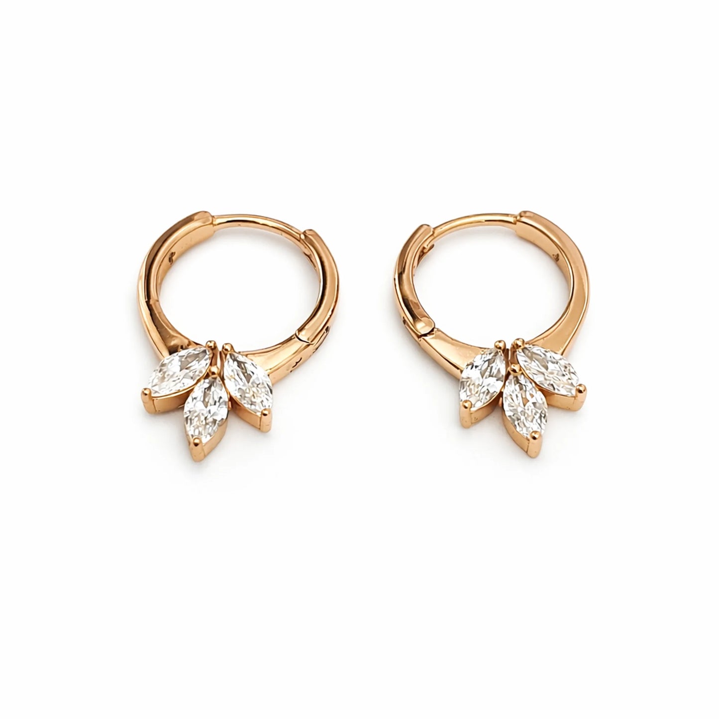 Rose gold hoop earrings with diamond-like stones on a white background