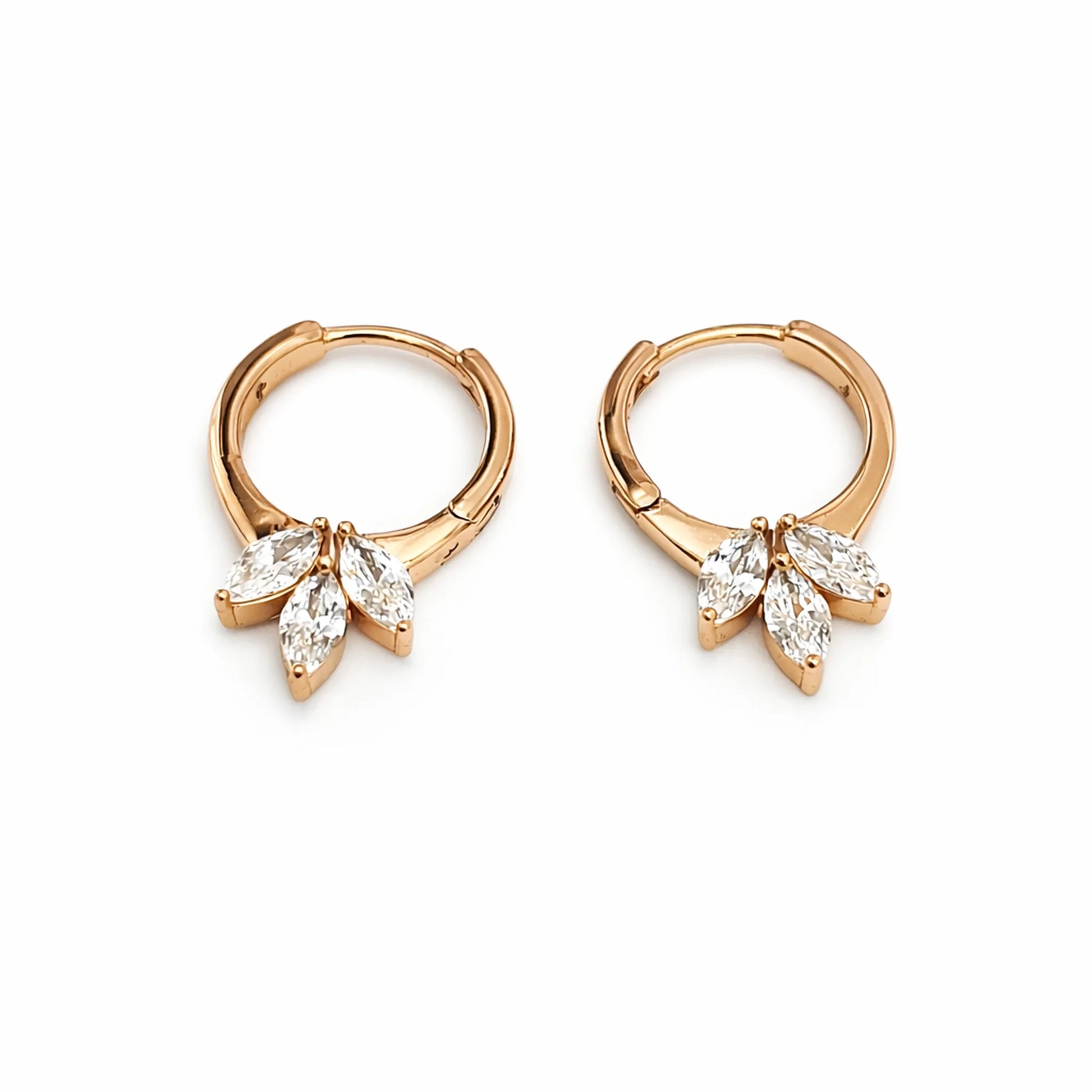 Rose gold hoop earrings with diamond-like stones on a white background