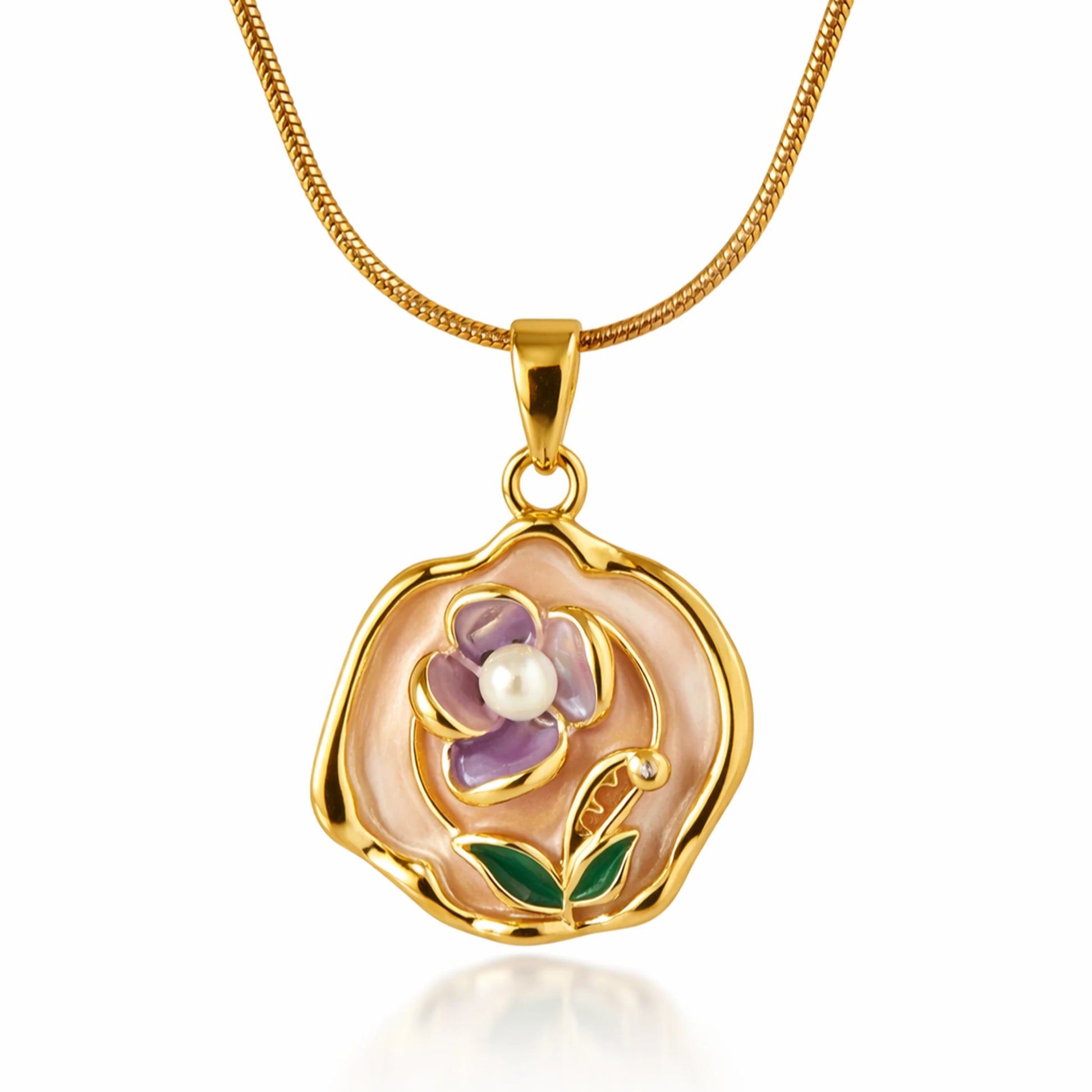 Gold pendant with floral design and pearl on a white background