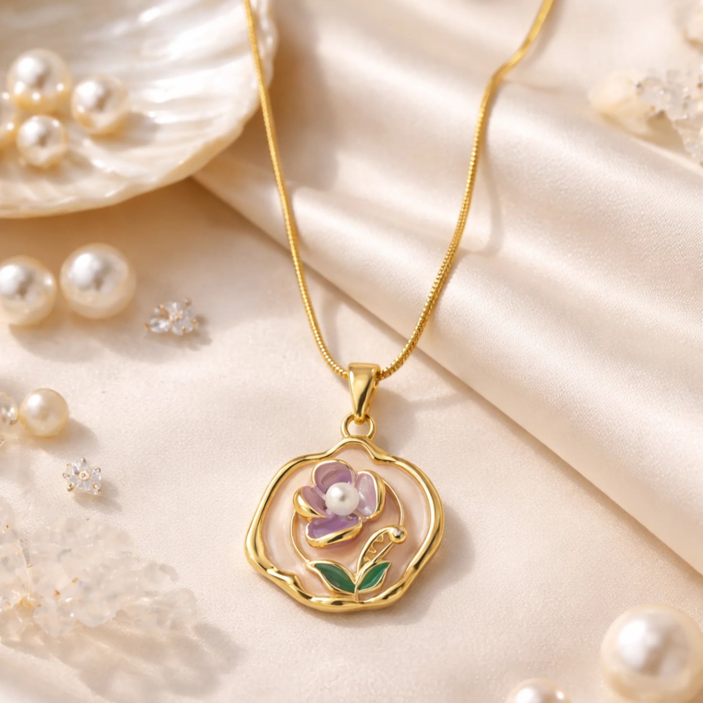 Gold necklace with a floral pendant on a soft beige background