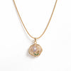 Gold necklace with a rose-shaped pendant on a white background