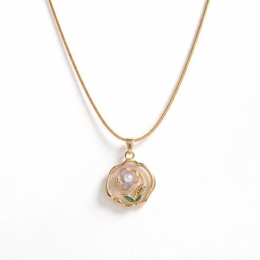 Gold necklace with a rose-shaped pendant on a white background