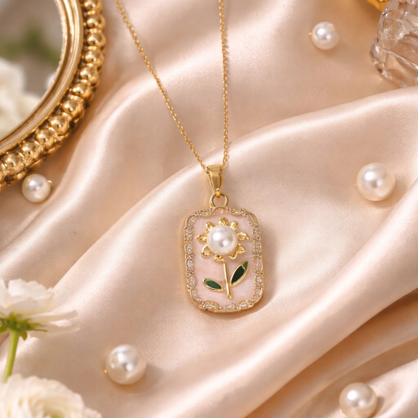 Anti-tarnish gold polish floral pendant necklace styled on satin fabric with pearl accents for an elegant lifestyle look