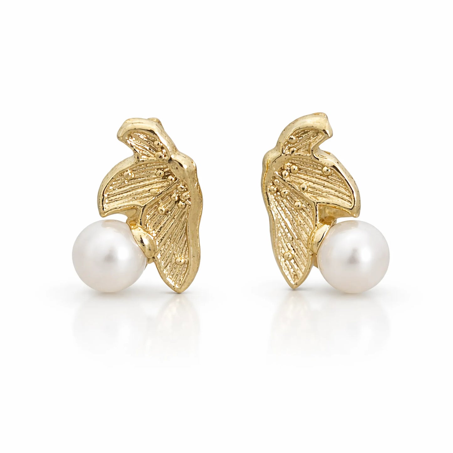 Close up of YUBIRAA gold pearl leaf earrings detailing textured leaf motif and glossy pearl with premium anti tarnish finish