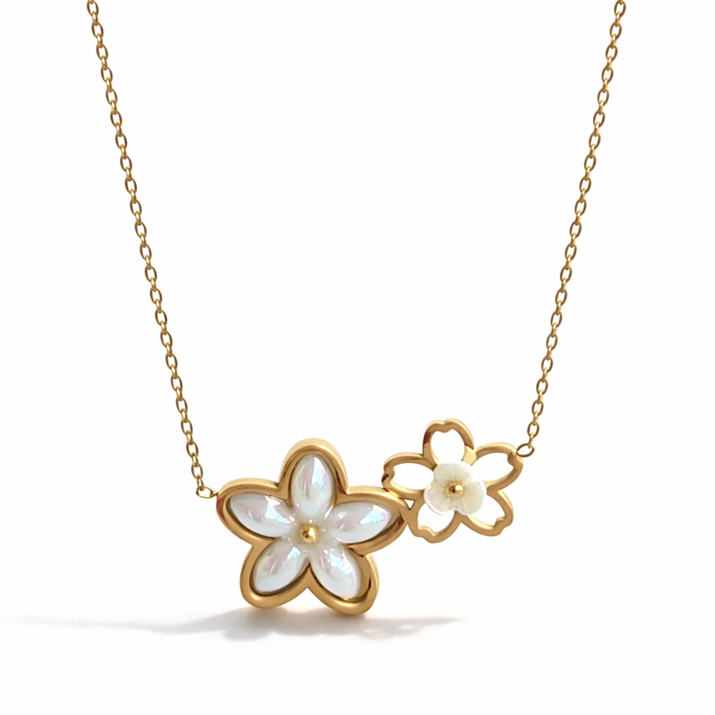 Gold necklace with flower-shaped pendants on a white background