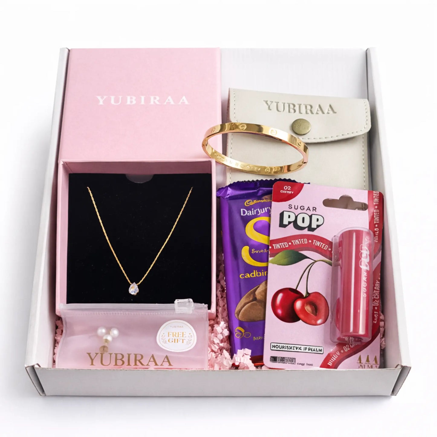 Gift box from Yubiraa containing a necklace, bracelet, candy, and lip balm.