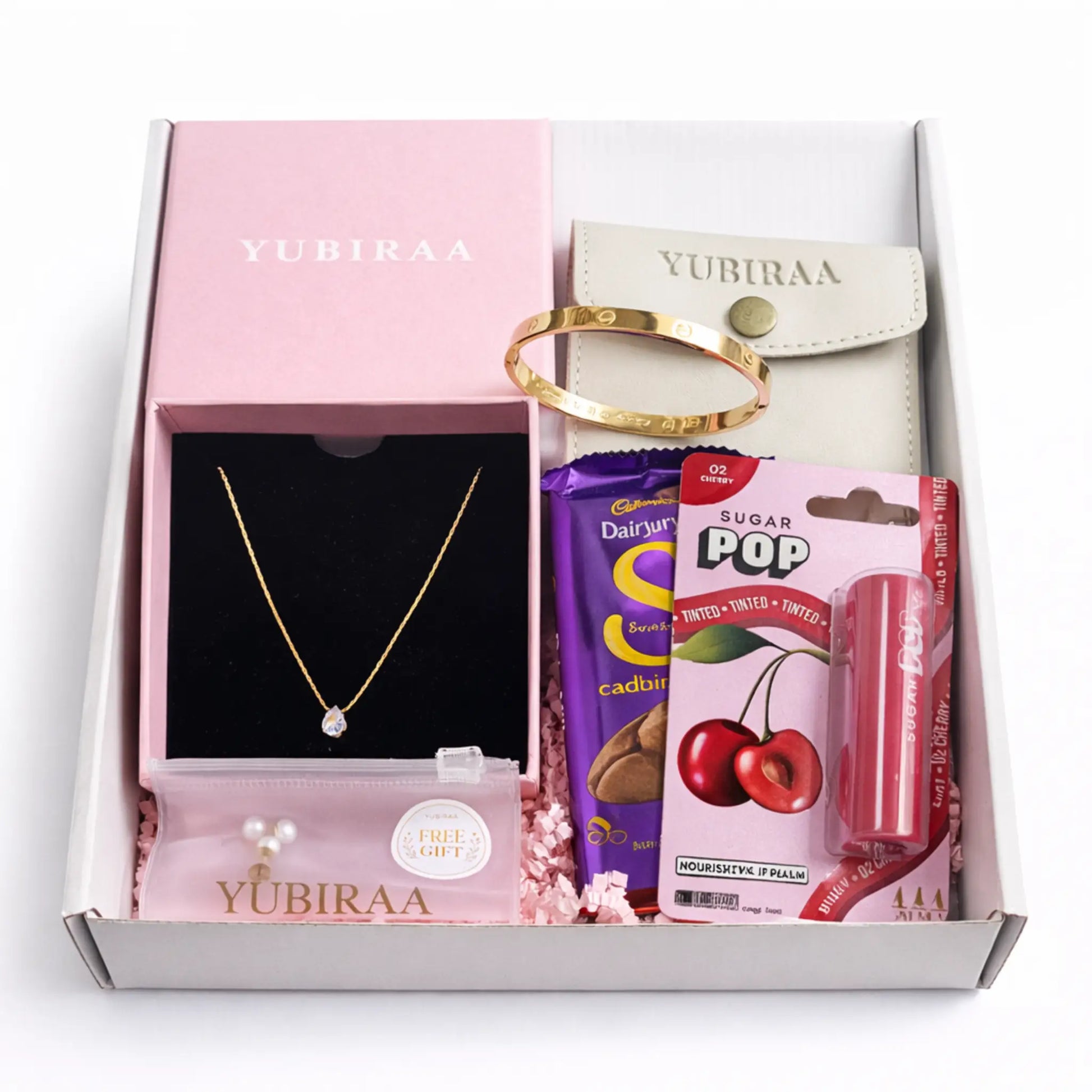 Gift box from Yubiraa containing a necklace, bracelet, candy, and lip balm.