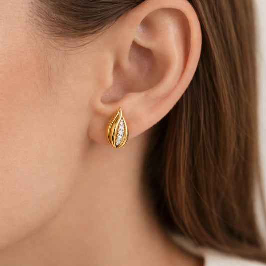 Petal Glow gold lever back earrings worn on ear close up view