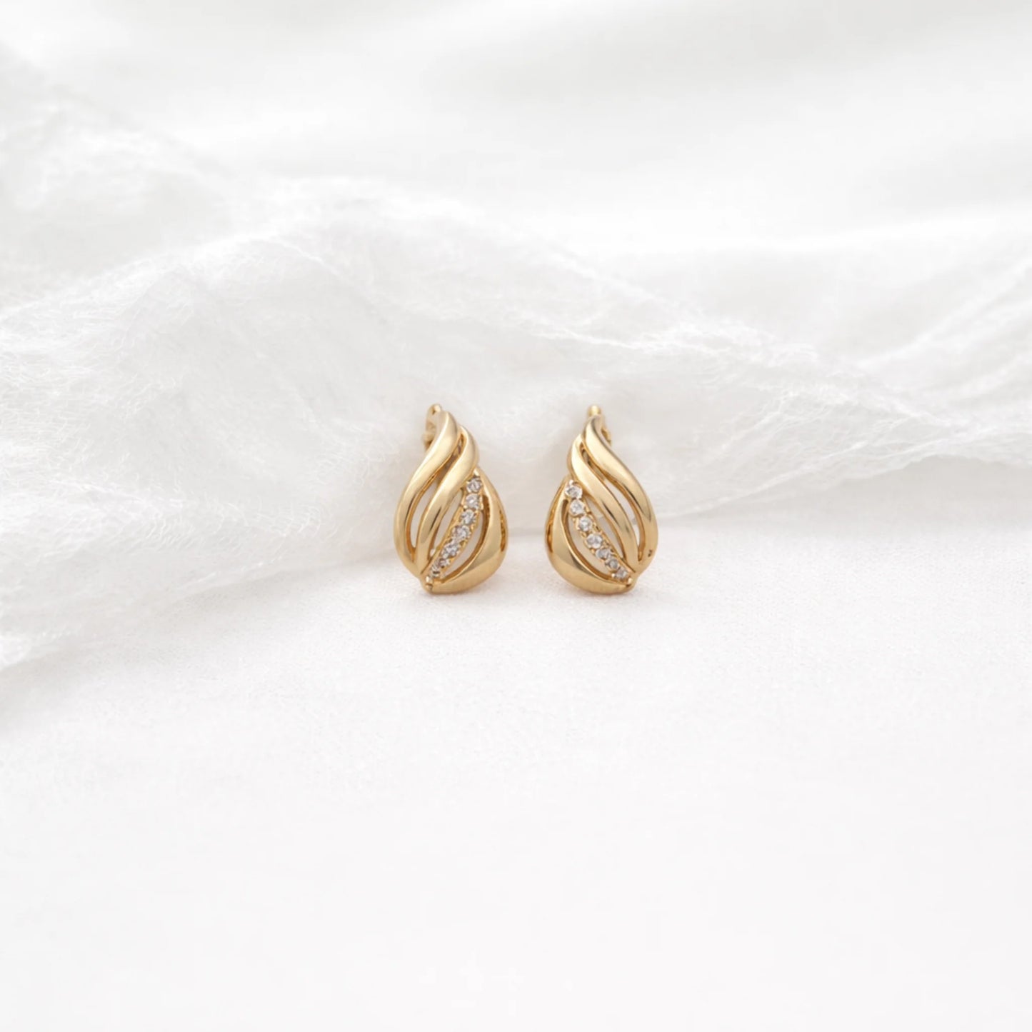Petal Glow gold earrings featuring elegant petal design with sparkling stone accents