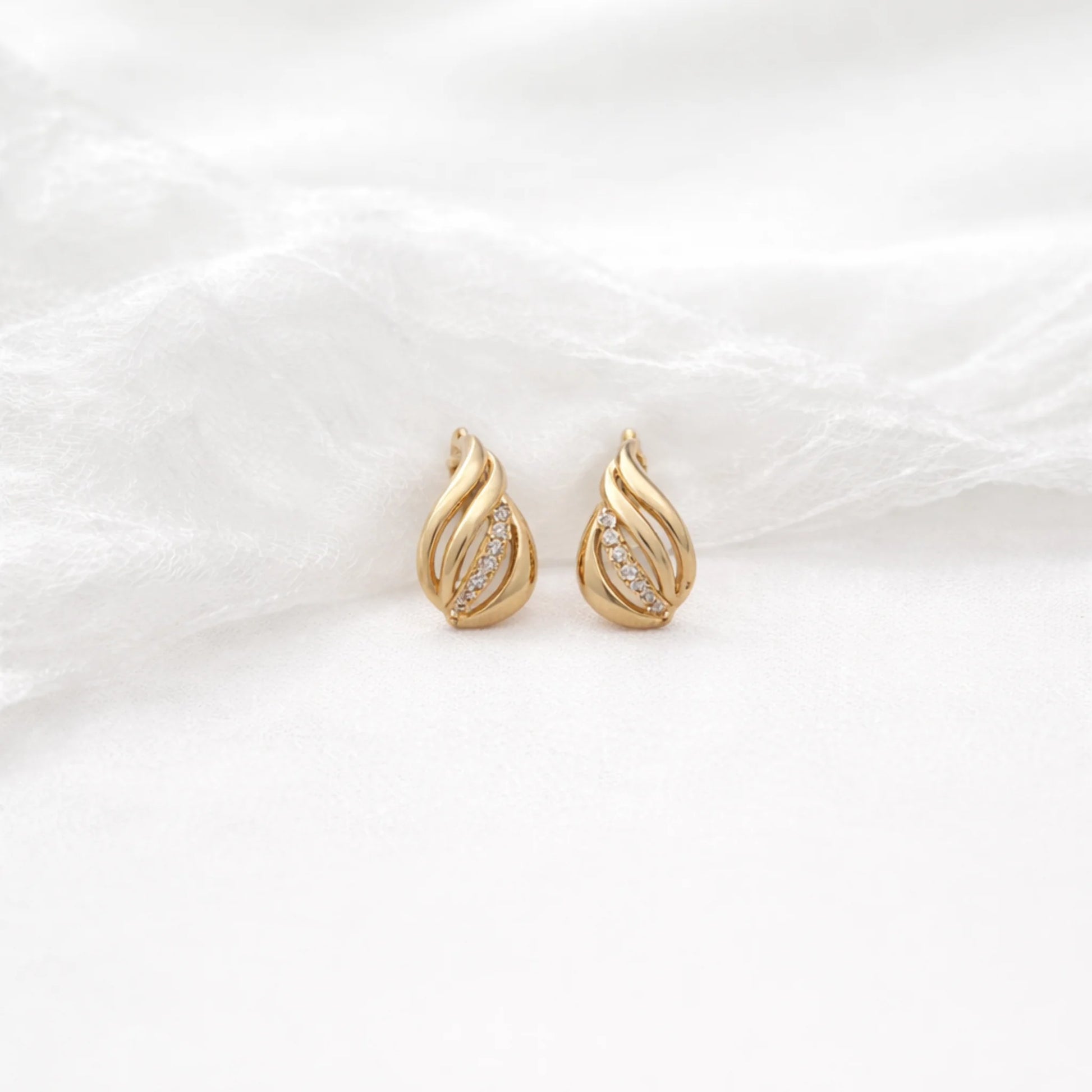 Petal Glow gold earrings featuring elegant petal design with sparkling stone accents