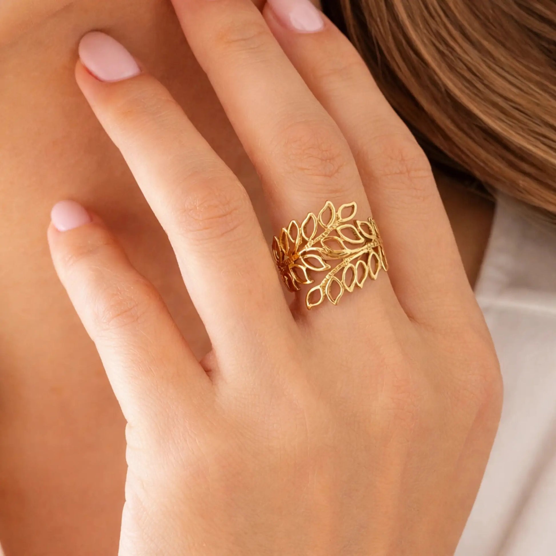 Model wearing gold leaf ring with elegant open leaf design and minimal aesthetic – yubiraa