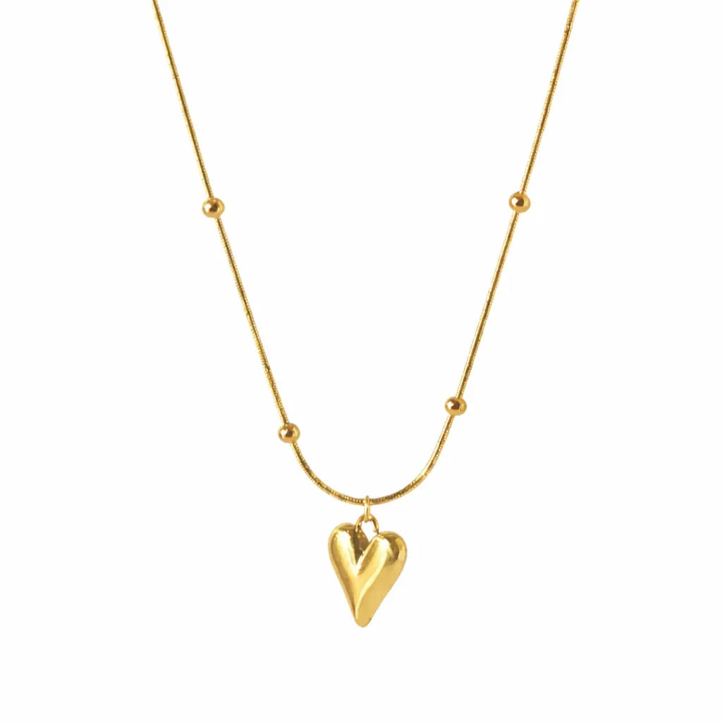 Minimal gold heart pendant necklace on white background, elegant everyday wear jewelry