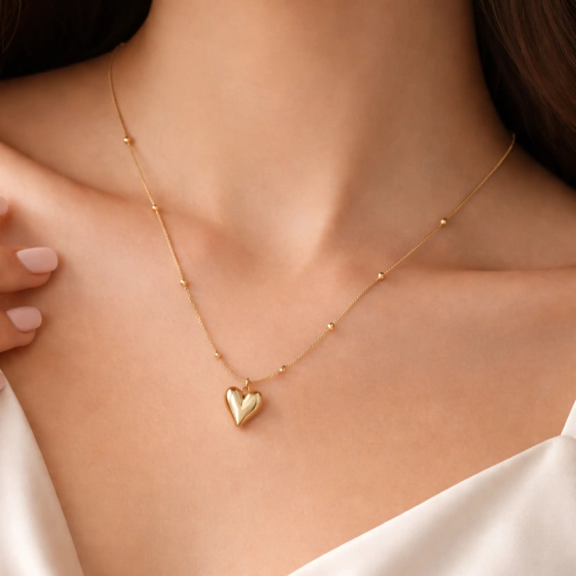 Minimal gold heart pendant necklace worn on neck with delicate bead chain, everyday gold jewelry