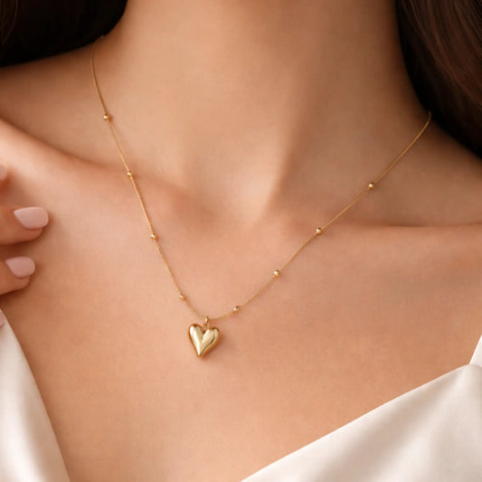 Minimal gold heart pendant necklace worn on neck with delicate bead chain, everyday gold jewelry