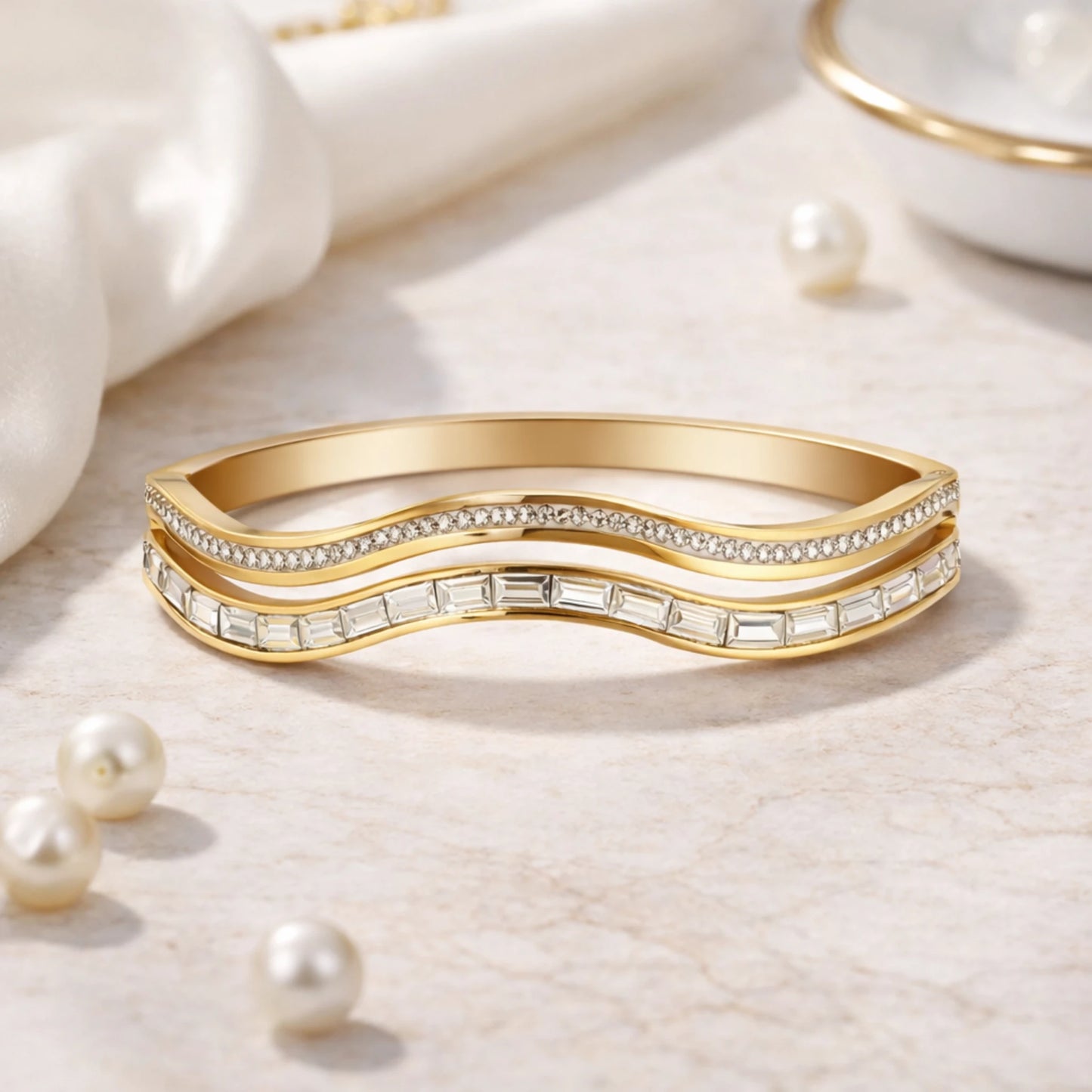 Gold bracelet with diamond accents on a light background