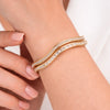 yubiraa anti tarnish Gold plated bracelet with clear stones on a wrist against a neutral background